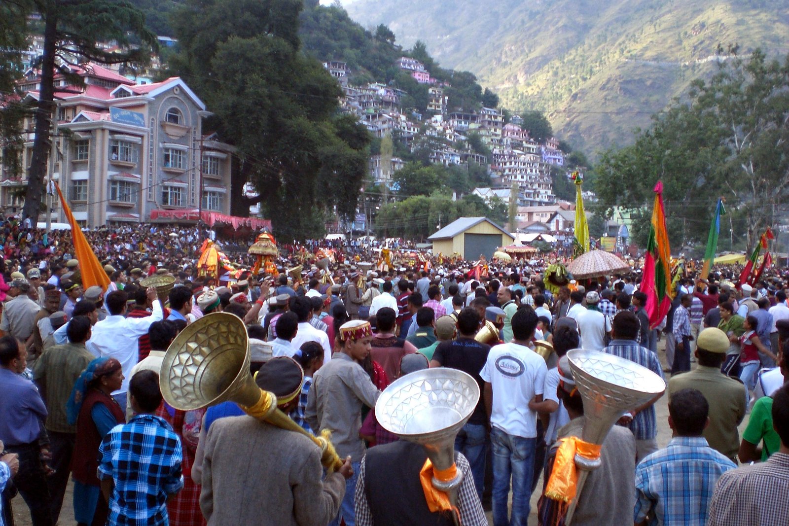 Crowds, deity palanquins and traditional brass horns during the main Kullu Dussehra procession at Dhalpur ground
