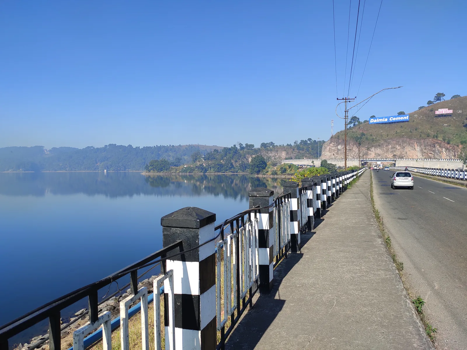 Road beside Umiam Lake on the Guwahati to Shillong self-drive route in Meghalaya