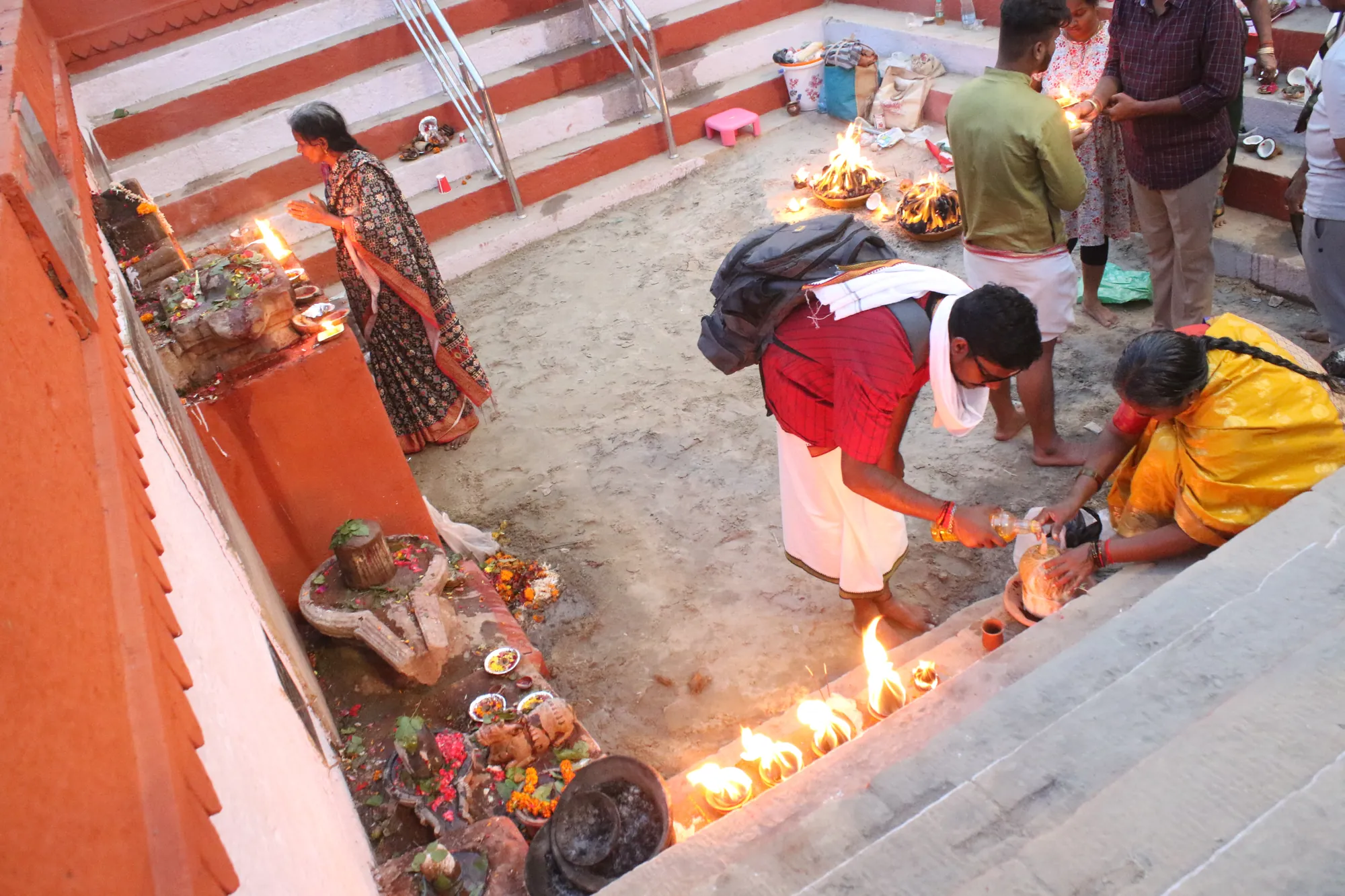 Devotees lighting diyas on the steps of a Varanasi ghat ahead of Dev Deepawali