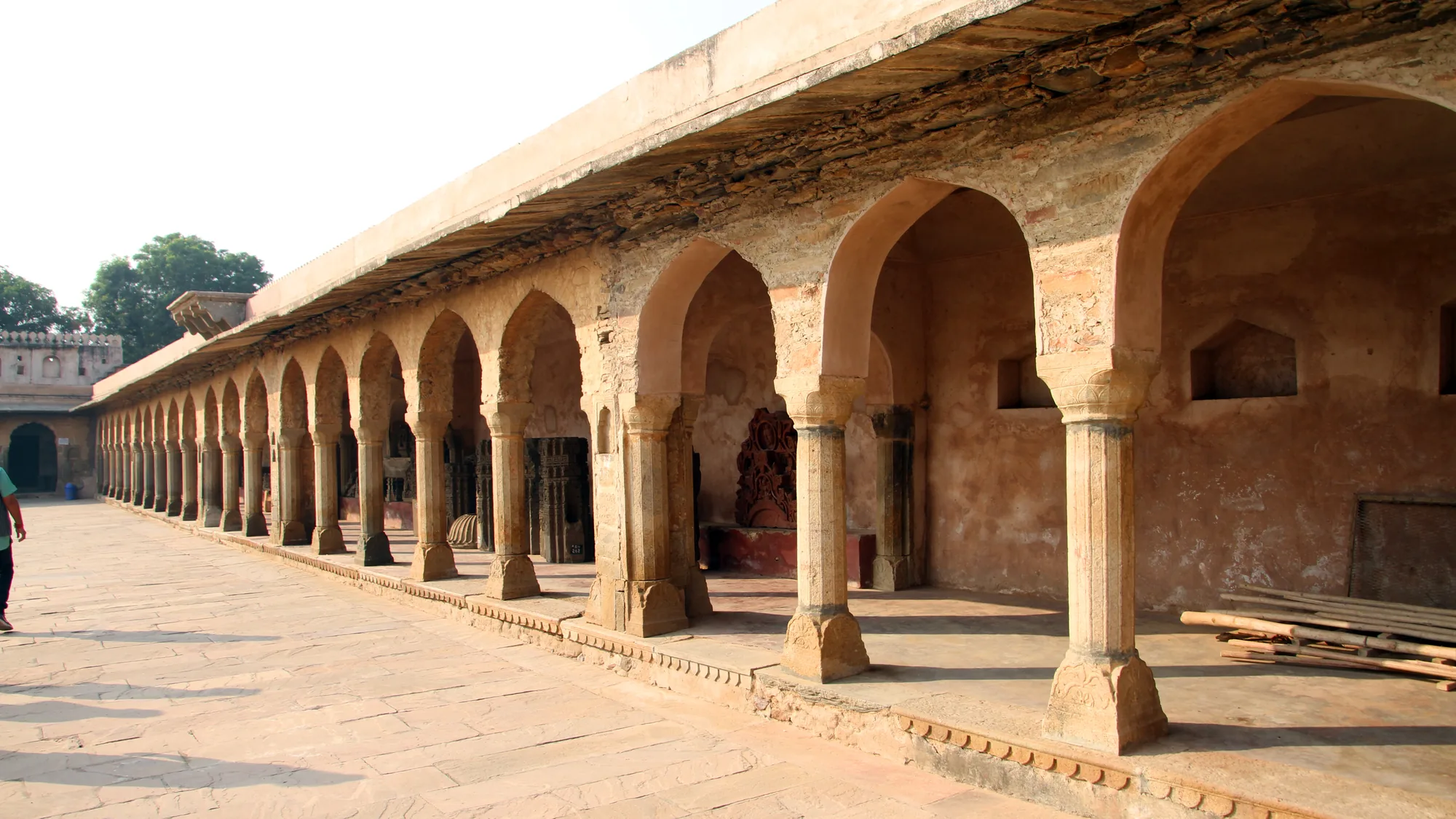 Sandstone colonnade and carved arches beside Chand Baori in Abhaneri village, part of a quiet October drive from Jaipur
