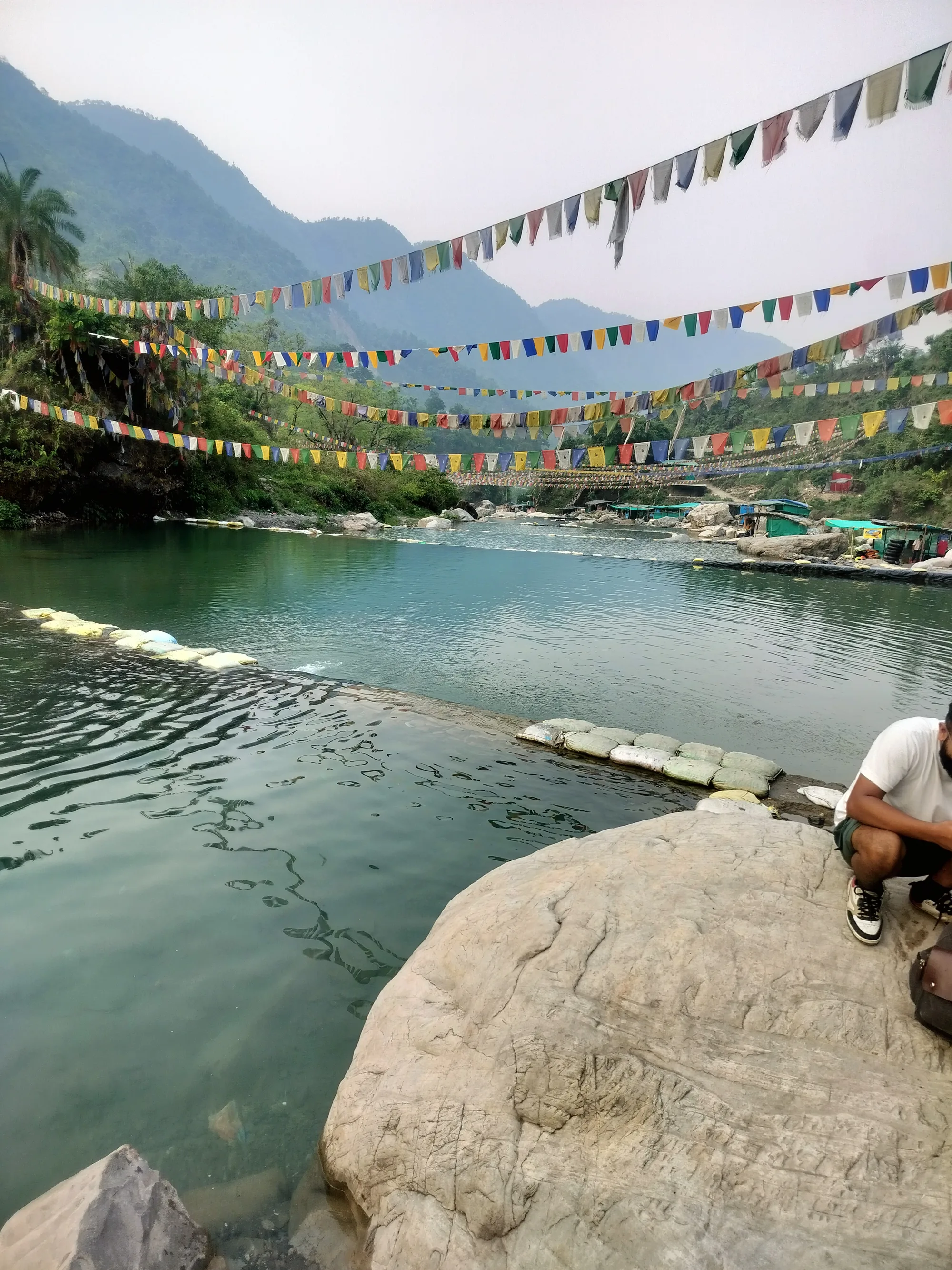 Prayer flags strung over the clear pools of the Baldi stream at Sahastradhara near Dehradun