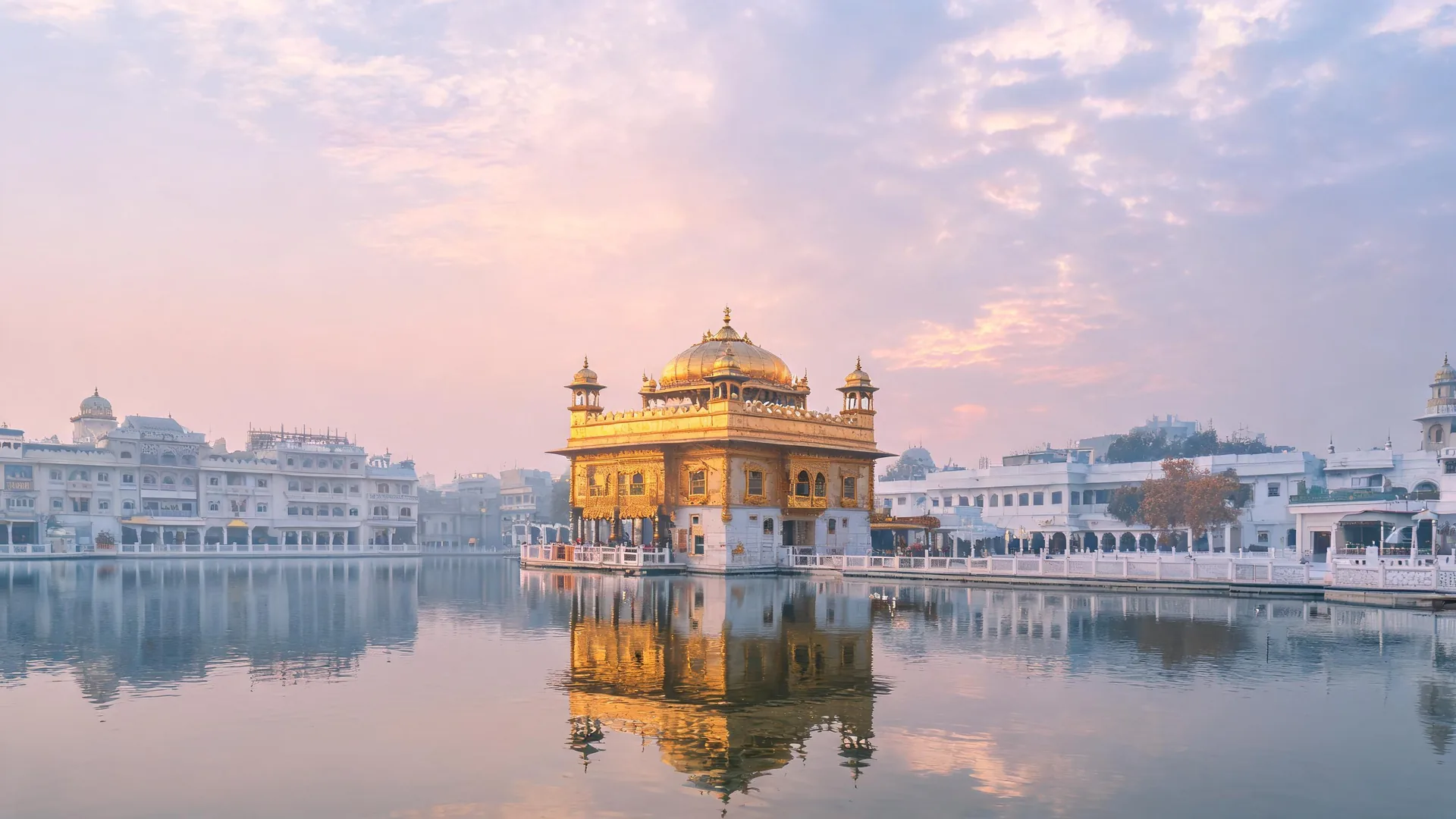 Golden Temple Harmandir Sahib reflecting in the sarovar at dawn, a calm start for car rental in Amritsar