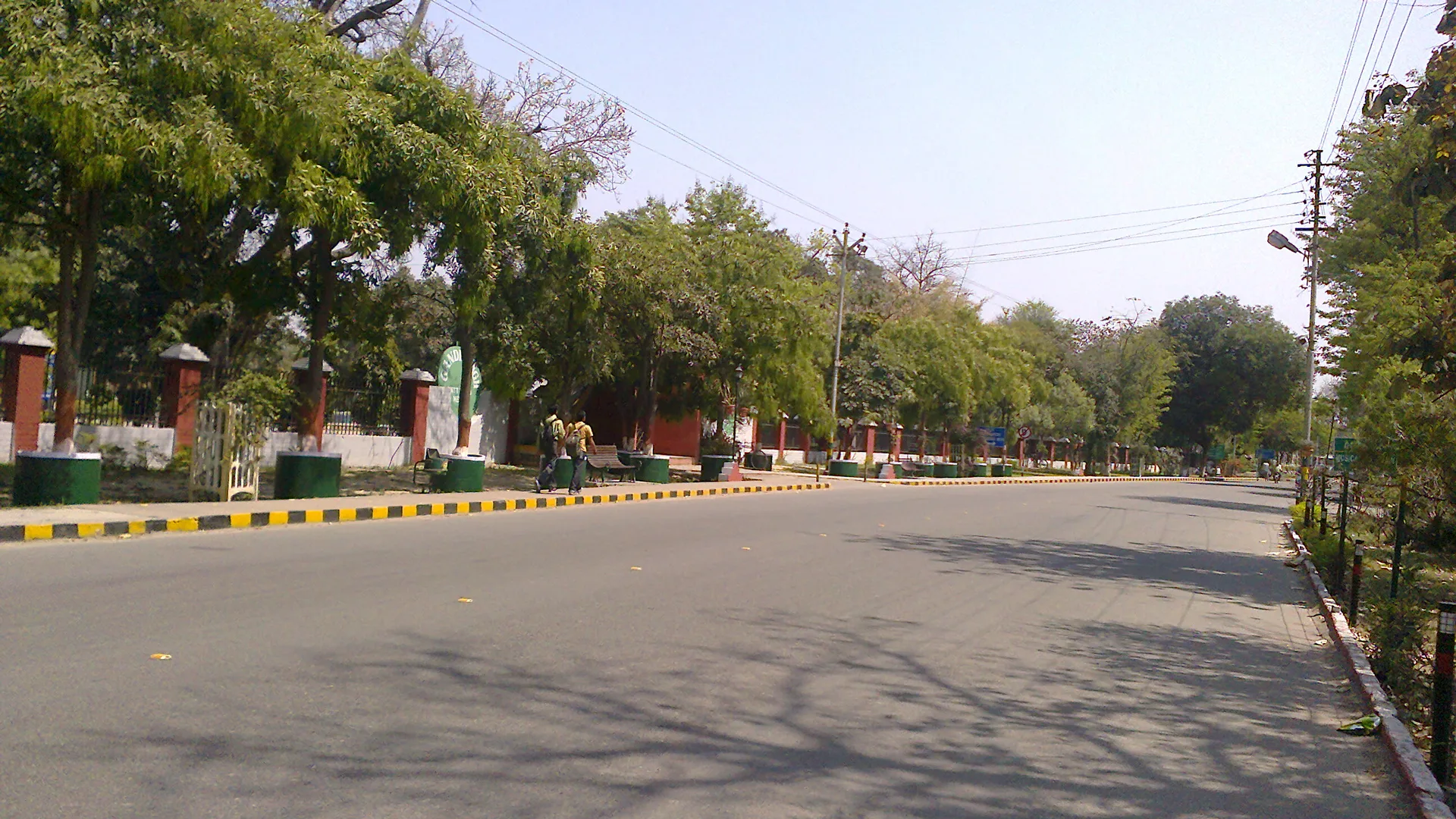 Wide tree-lined Mall Road in Meerut Cantonment, the kind of calm drive you get with car rental in Meerut