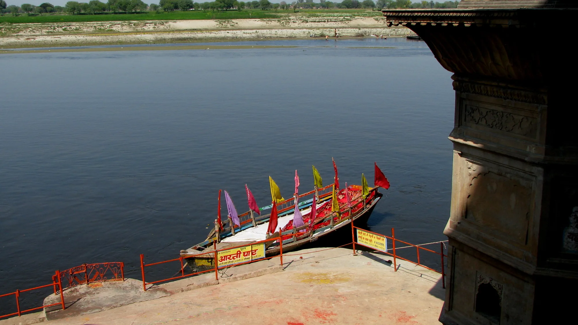 Boat moored at a Yamuna ghat in Vrindavan, a calm riverside pause on a Noida self-drive temple day