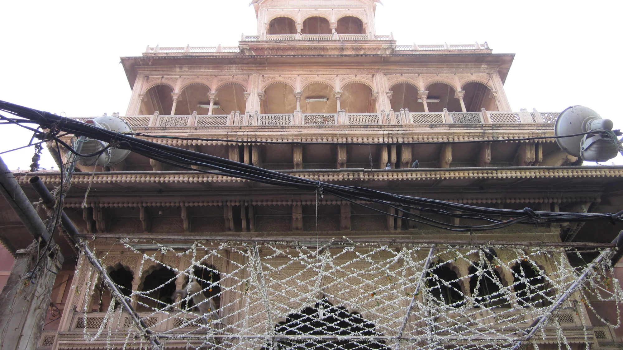 Sandstone facade of Banke Bihari Temple in Vrindavan — park outside the lanes and walk the final stretch