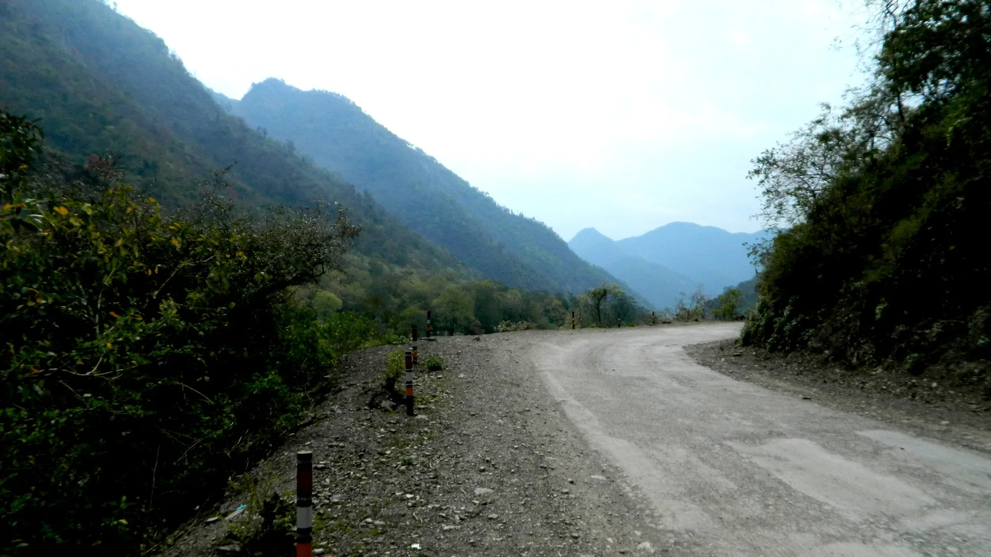 Winding mountain road toward Rishikesh hills — the Narendranagar approach for a Kunjapuri sunrise bike ride