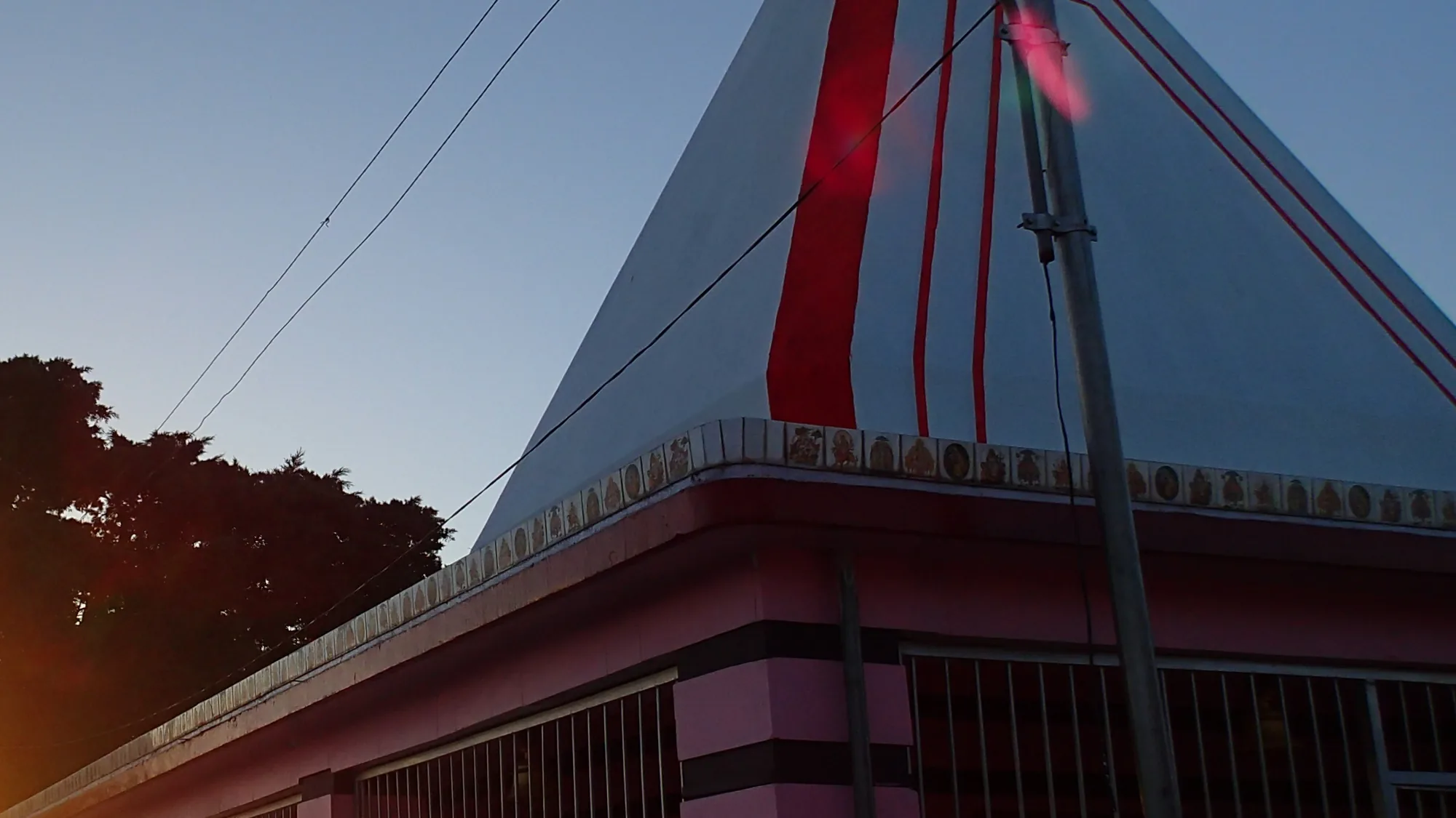 Kunjapuri Devi Temple pink walls and white shikhara at dawn after a bike rental ride from Rishikesh