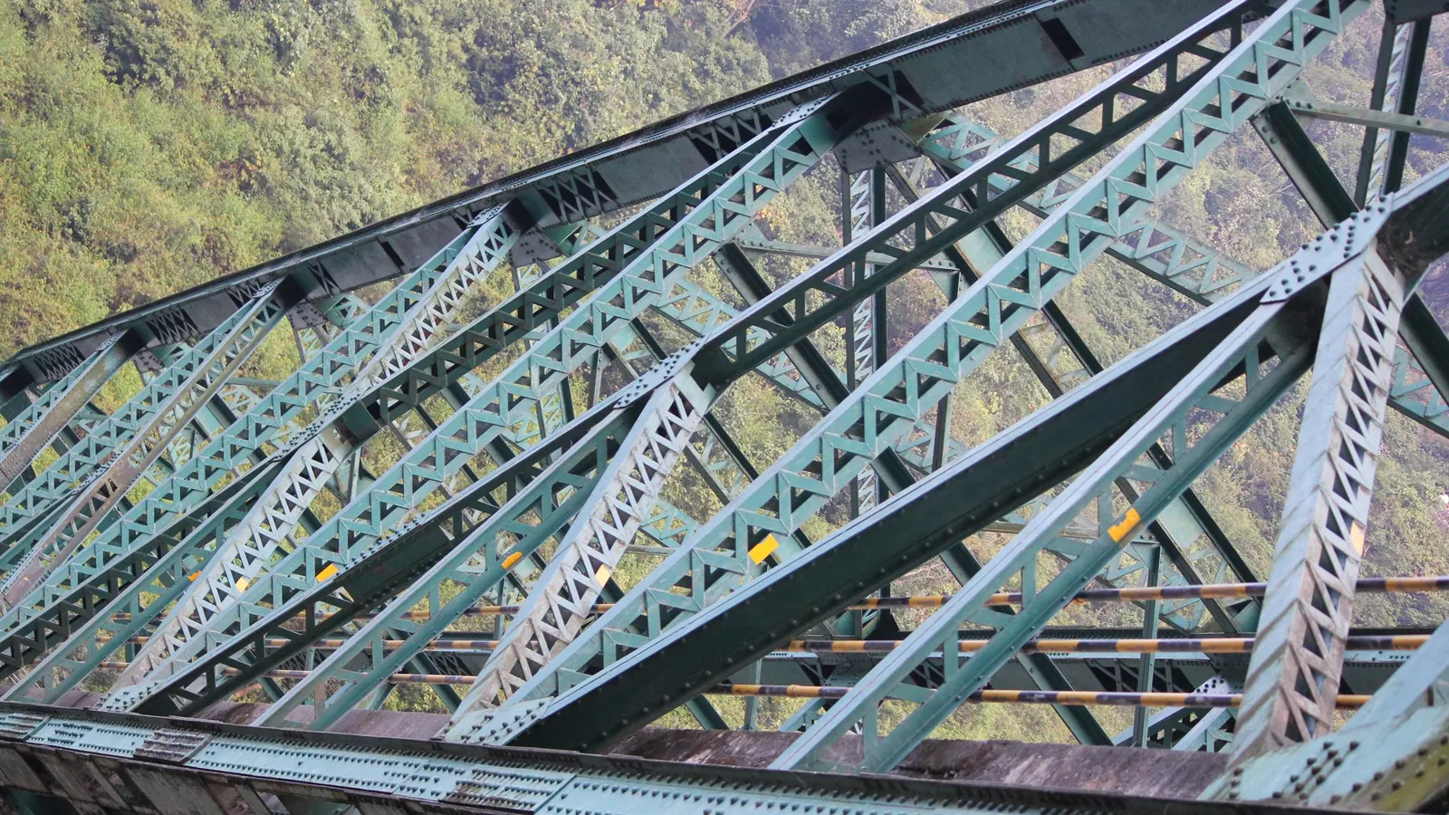 Green steel truss of Yamuna Bridge below Mussoorie, where the bike route to Barkot crosses the river