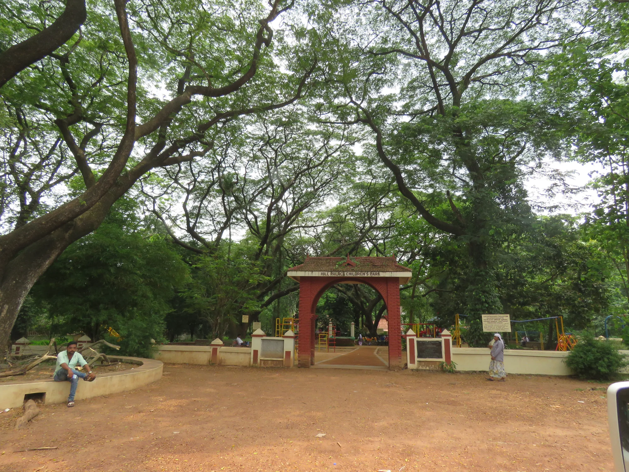 Hill Palace Children's Park entrance arch under trees at Tripunithura, a stop on bike rental in Cochin trips