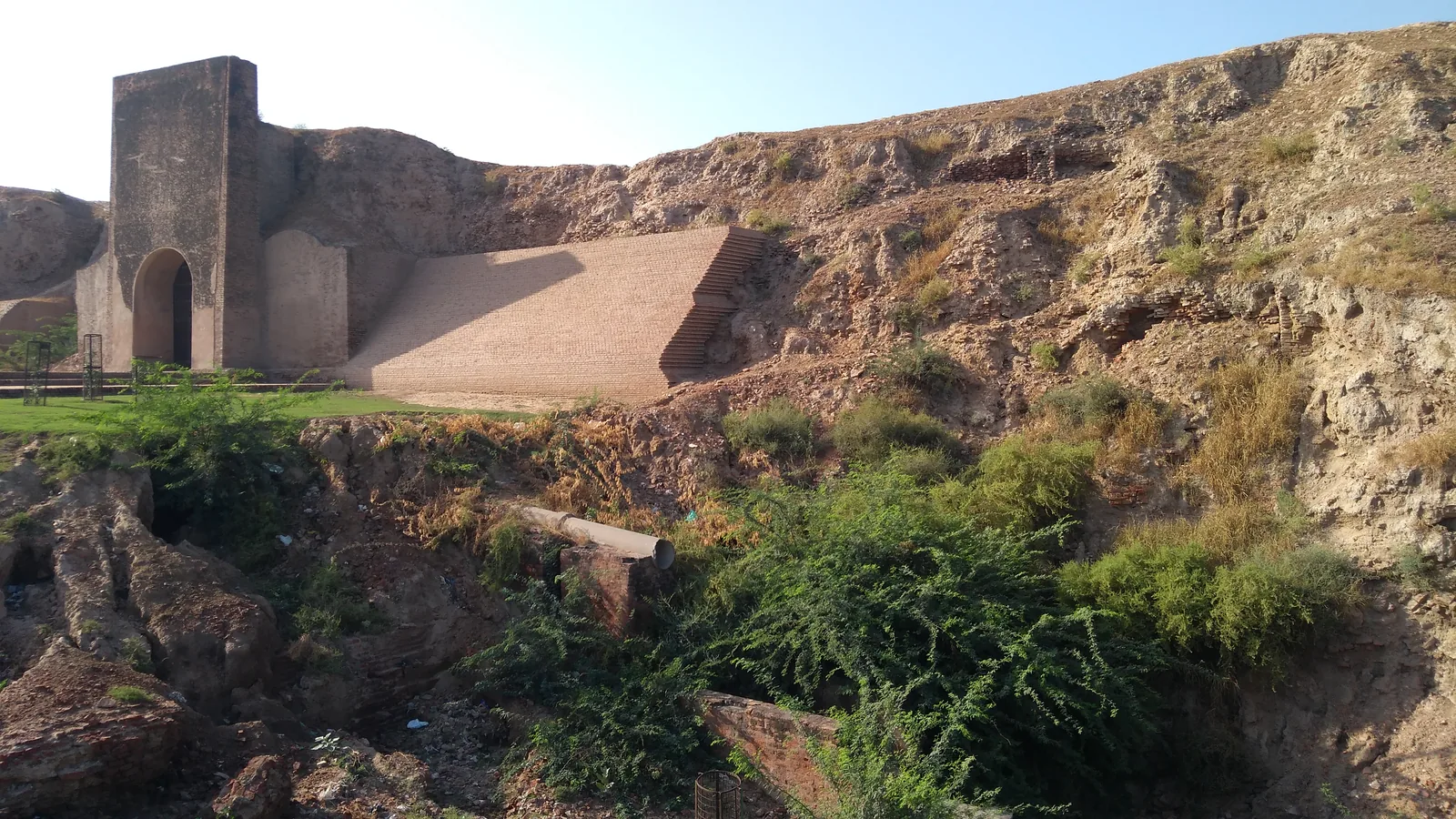 Brick ramp and old gateway set into the earthen rampart of Asigarh Fort in Hansi, on the NH9 route from Rohtak to Rakhigarhi