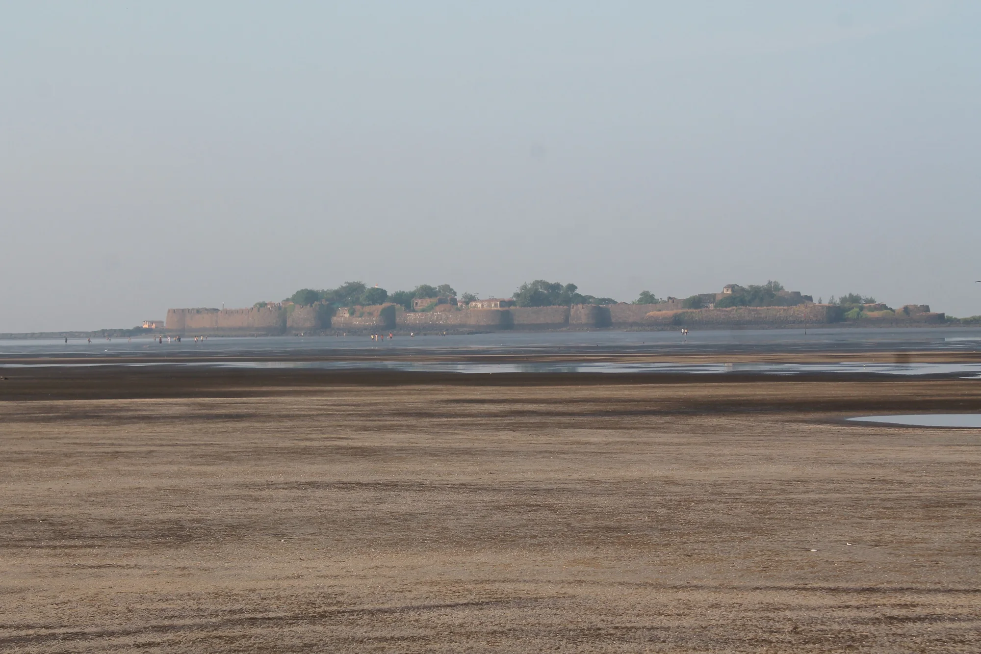 Kolaba Fort island walls at low tide off Alibaug beach, a stop on a self-drive car rental in Mumbai weekend