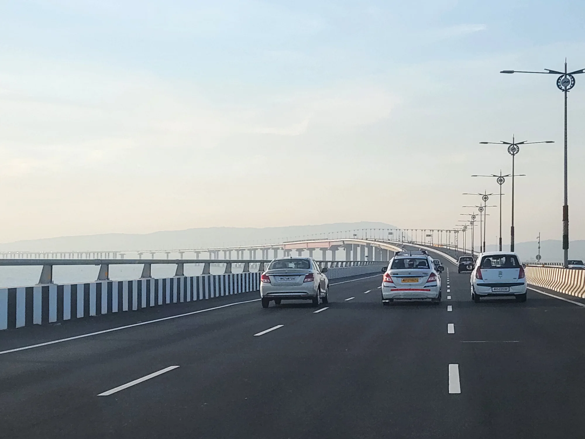 Cars driving across Atal Setu Mumbai Trans Harbour Link toward Navi Mumbai on a self-drive to Alibaug