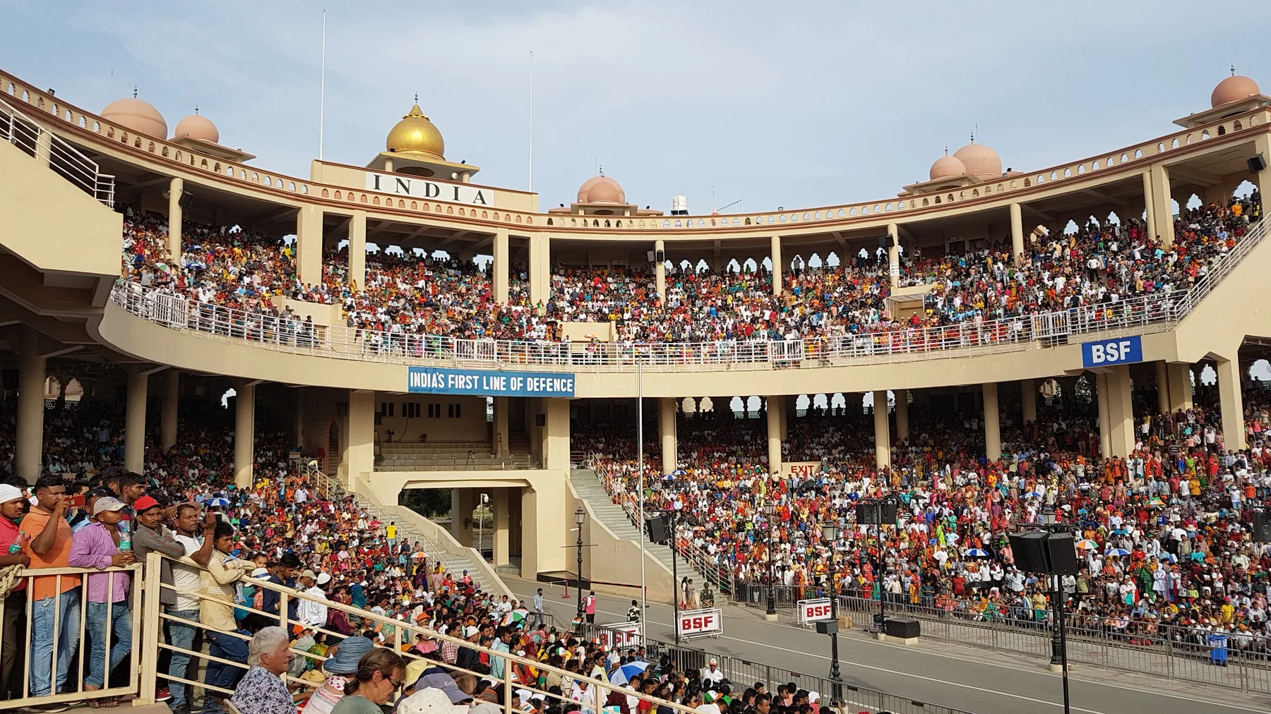 Crowded Indian grandstand at the Attari-Wagah border arena with INDIA lettering, the evening stop on an Amritsar car day