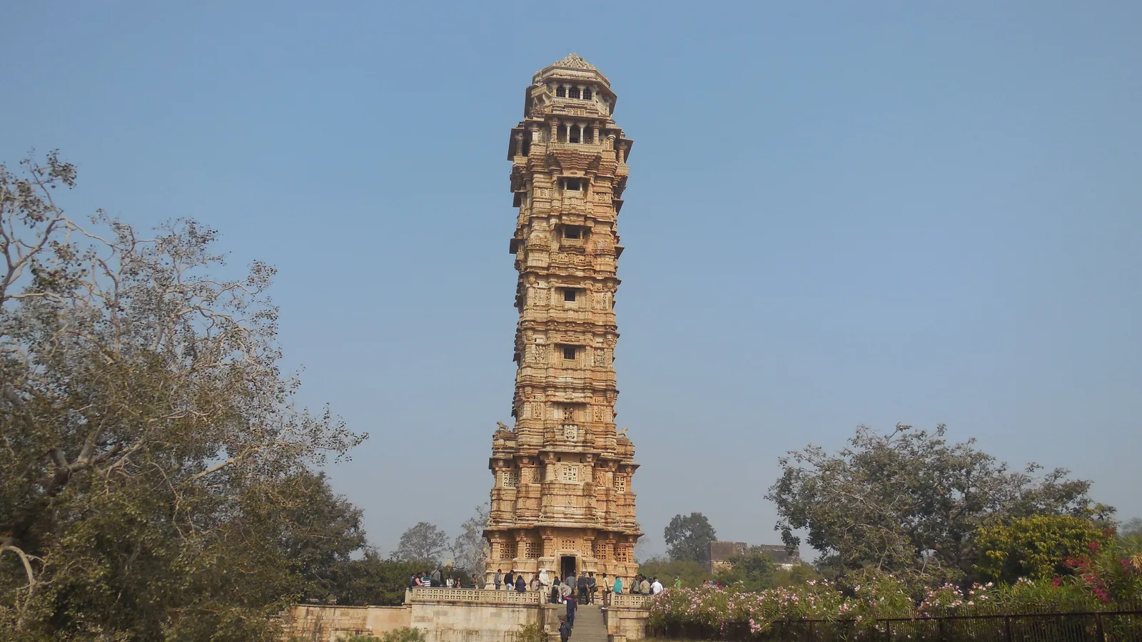 Vijay Stambh, the nine-storey carved Tower of Victory at Chittorgarh Fort, under a clear sky on a day trip by self-drive car rental in Udaipur