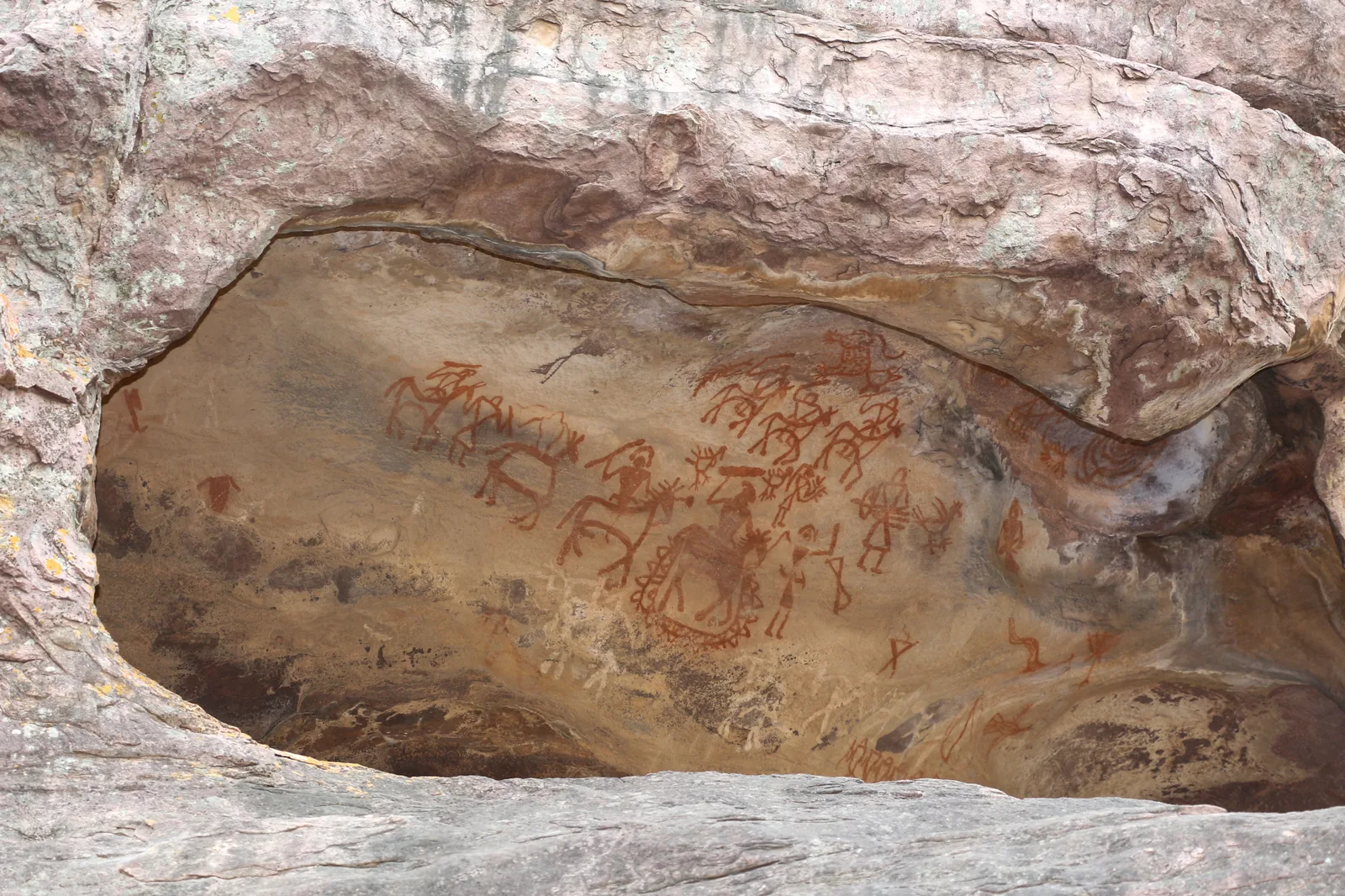 Wide sandstone rock shelter above forested slopes at Bhimbetka, Madhya Pradesh, on a day trip with self-drive car rental in Bhopal