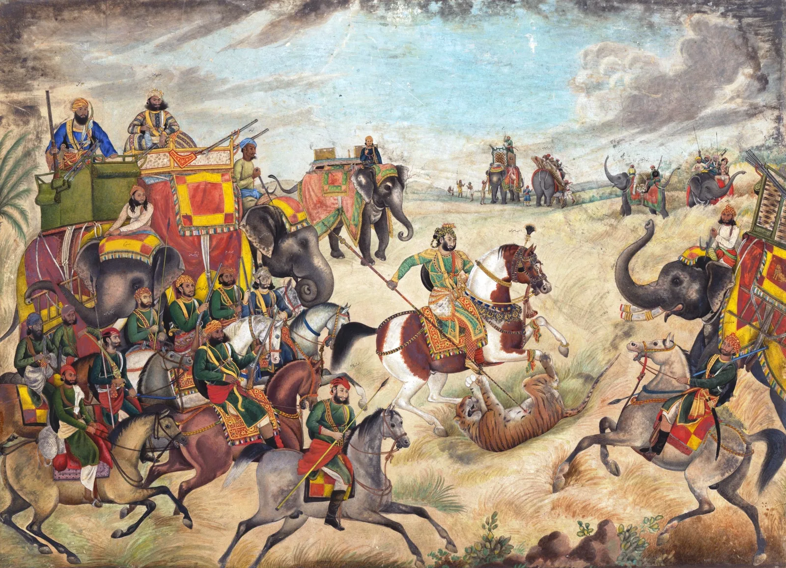 A colourful 19th-century painting of a tiger hunt at Jhajjar, with riders on horses and elephants and a nawab spearing a tiger