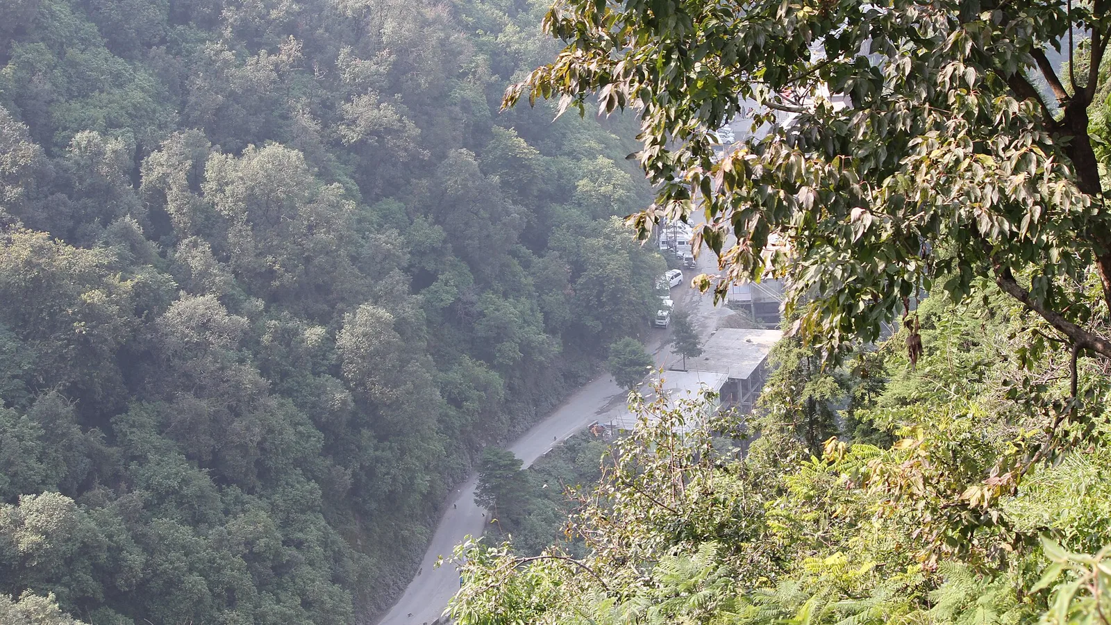 Forested slopes and a river valley below the hill town of Mussoorie in Uttarakhand