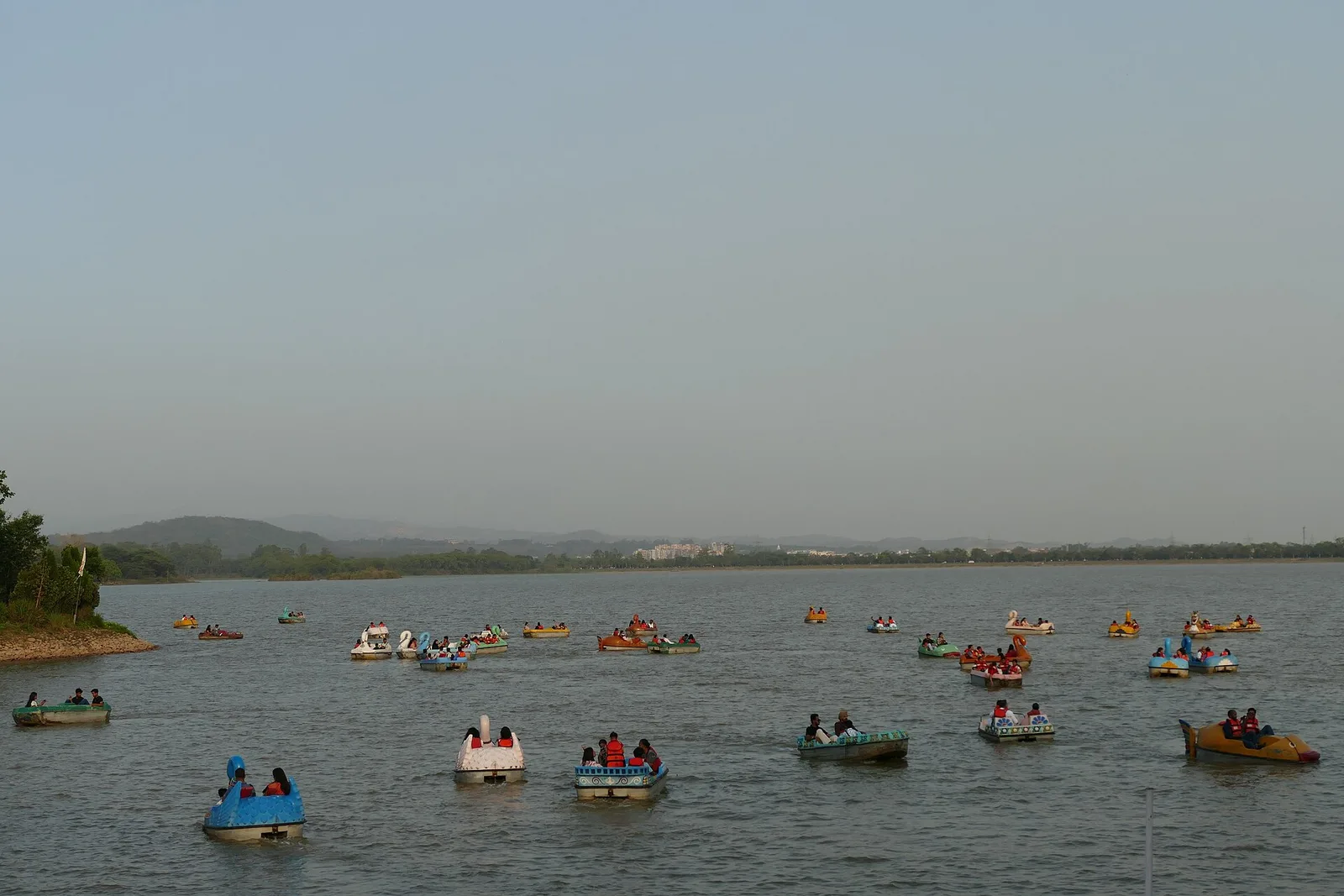 Pedal boats on Sukhna Lake in Chandigarh with the Shivalik hills behind