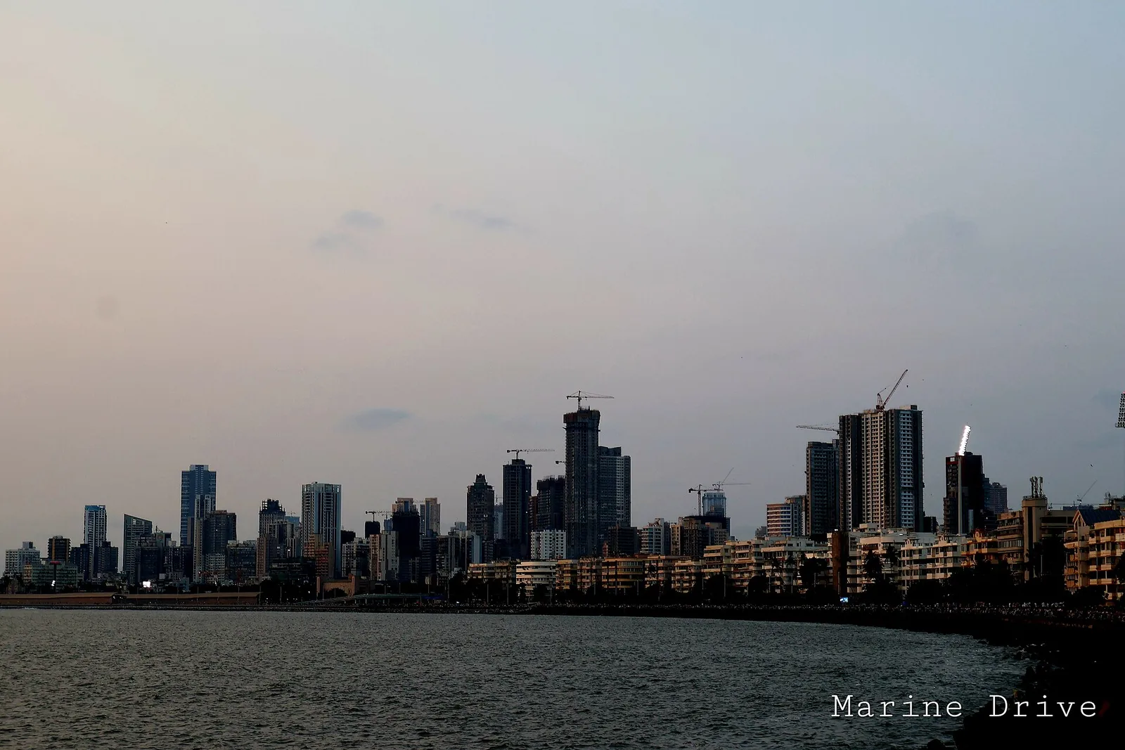 The Mumbai skyline along Marine Drive at dusk