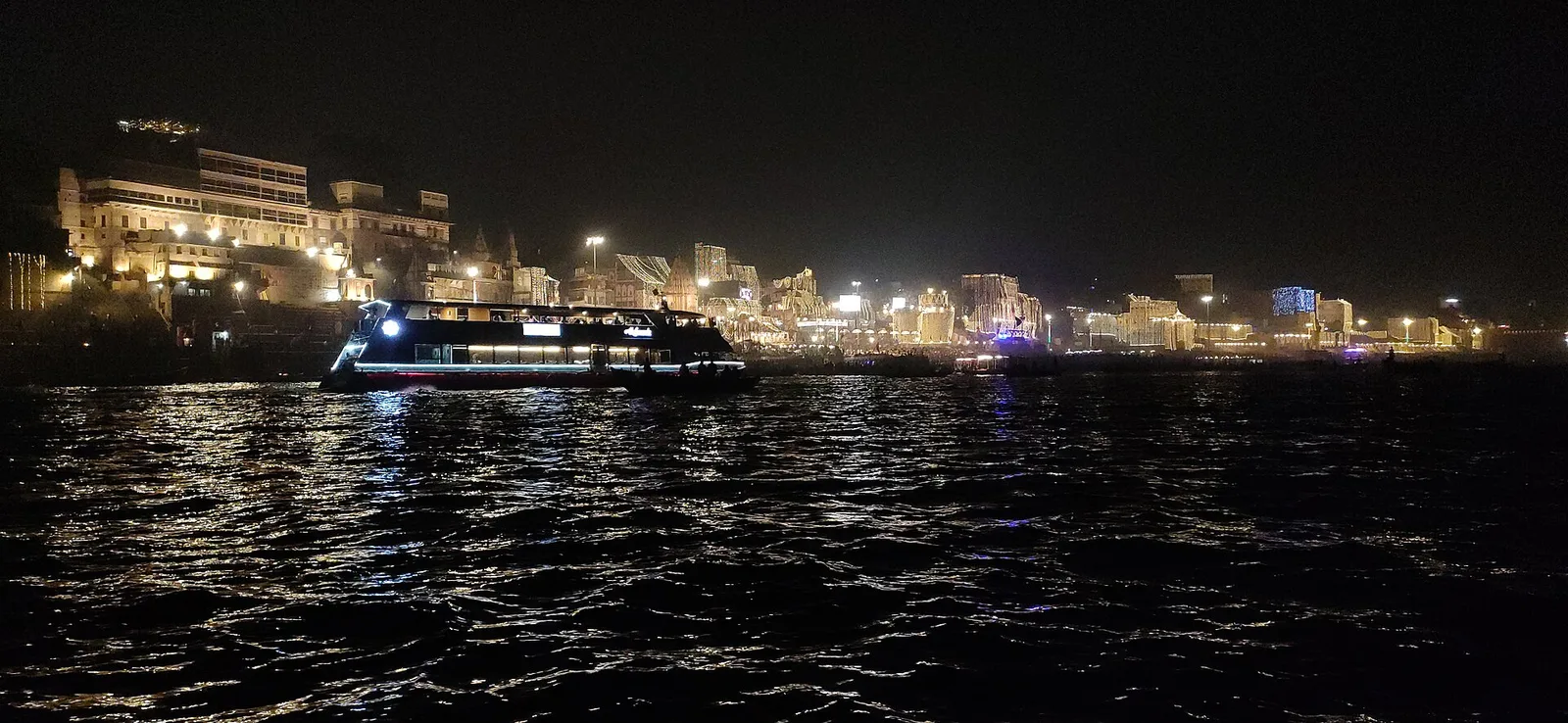 The ghats of Varanasi lit up at night along the Ganga