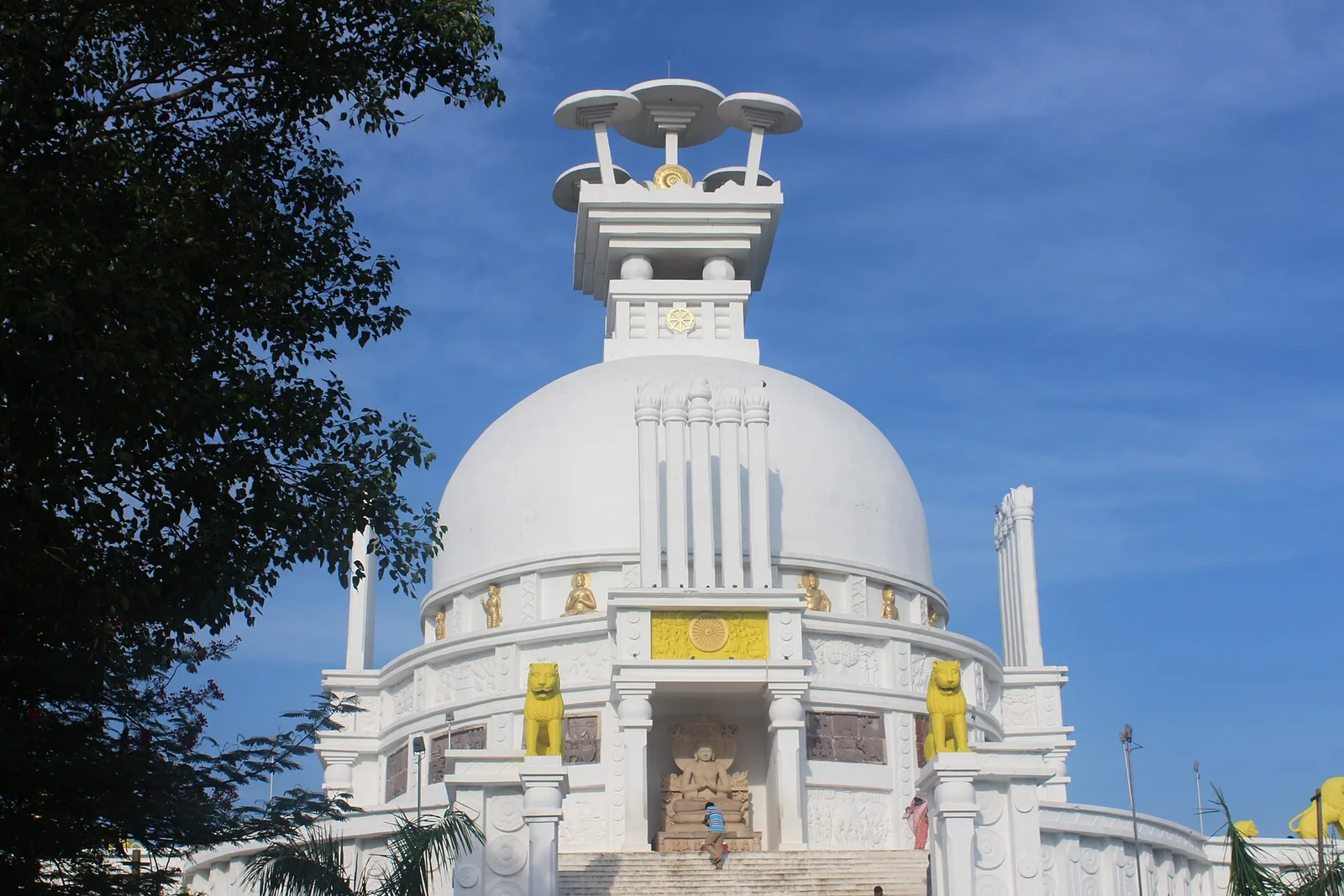 The white Dhauli Shanti Stupa against a blue sky