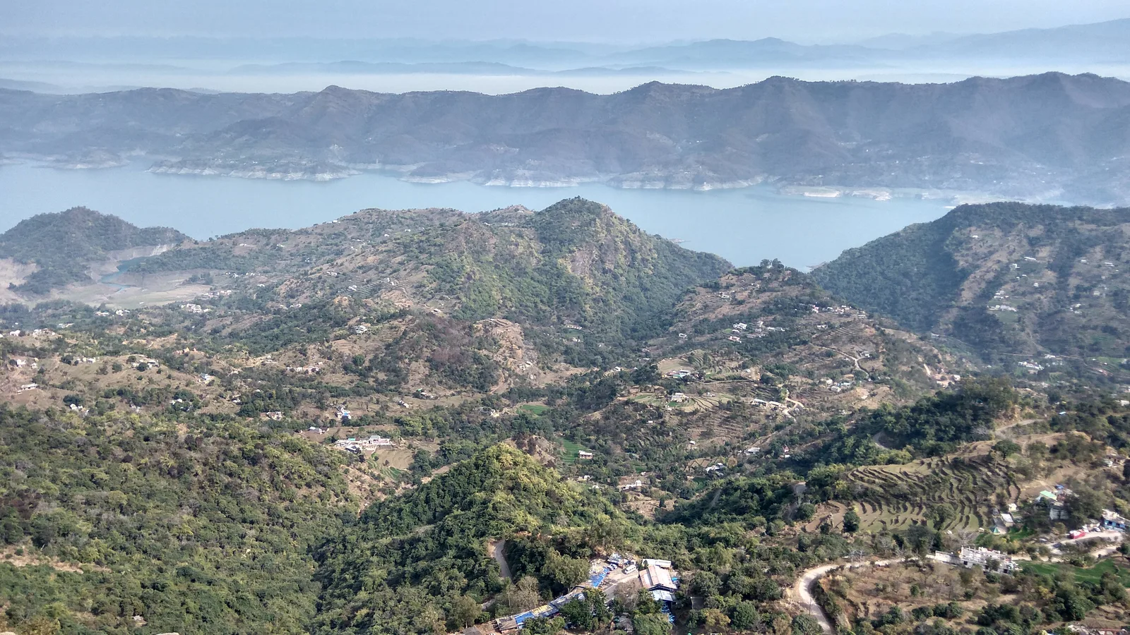 Gobind Sagar reservoir and dry, terraced hills seen from the Naina Devi hills in winter, near the Punjab and Himachal border