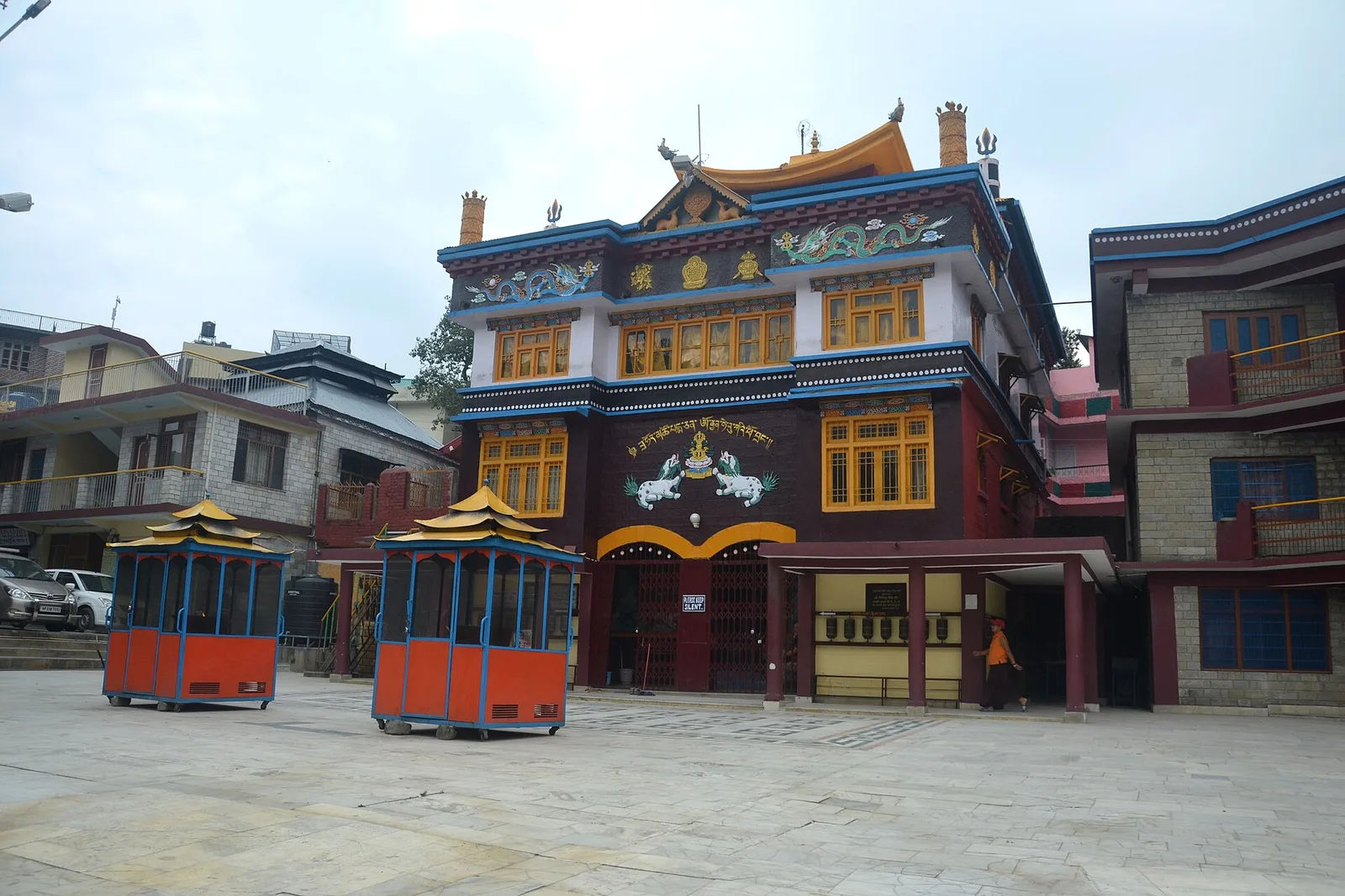 Painted facade of a Tibetan Buddhist monastery at Rewalsar with prayer wheel pavilions in the courtyard